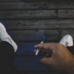 person holding cigarette stick