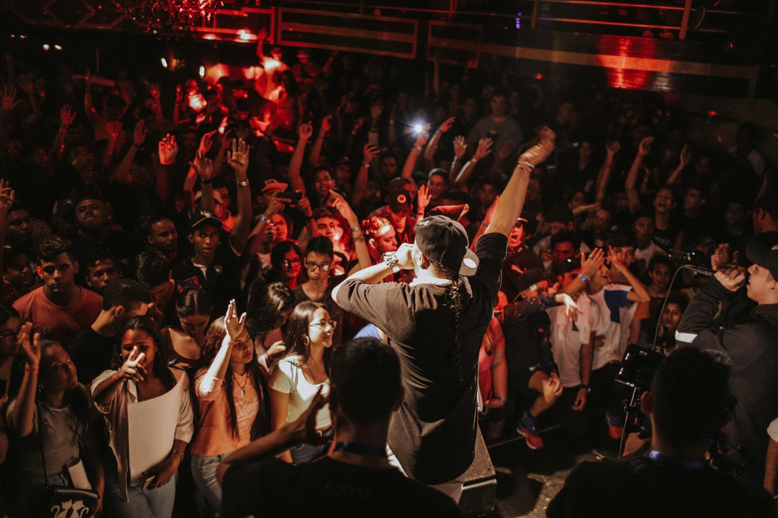 photo of man holding microphone standing on stage