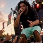 J. Cole performing live on stage at concert