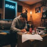 Rapper writing lyrics in recording studio