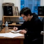Rapper writing lyrics in home studio