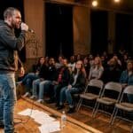Rap artist performing on community stage