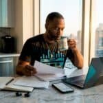 Rapper reviewing financial documents at table