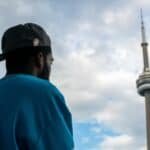Man in blue shirt looks at cn tower