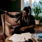 Lil Wayne in recording studio adjusting microphone