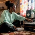 Music producer working at mixing console in studio