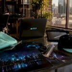 Merchandise and DJ equipment on a table with city view in background.
