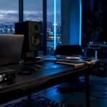 Music blogging workspace with audio equipment and promo materials
