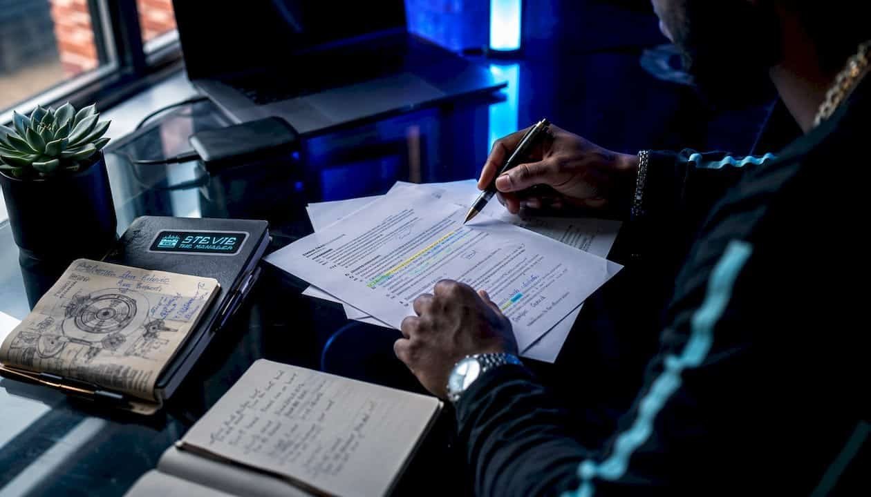 Hands examining music business contracts