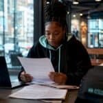 Emerging artist reviewing music contract at desk