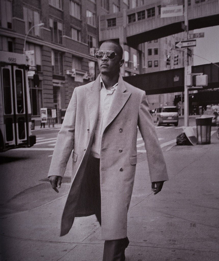 Stevie The Manager aka Stangr The Man walking in city street with sunglasses.