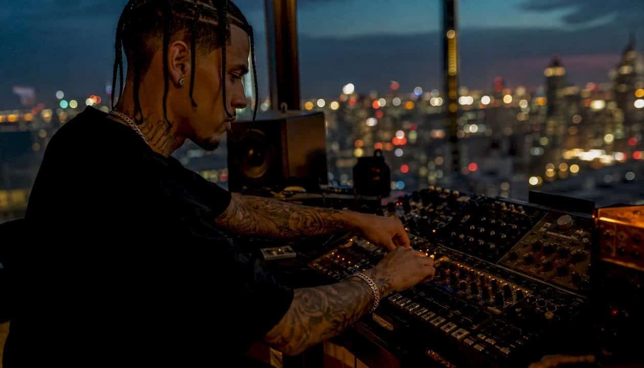 Hip-hop artist adjusting studio audio equipment