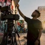 Hip-hop artist adjusting music video lighting