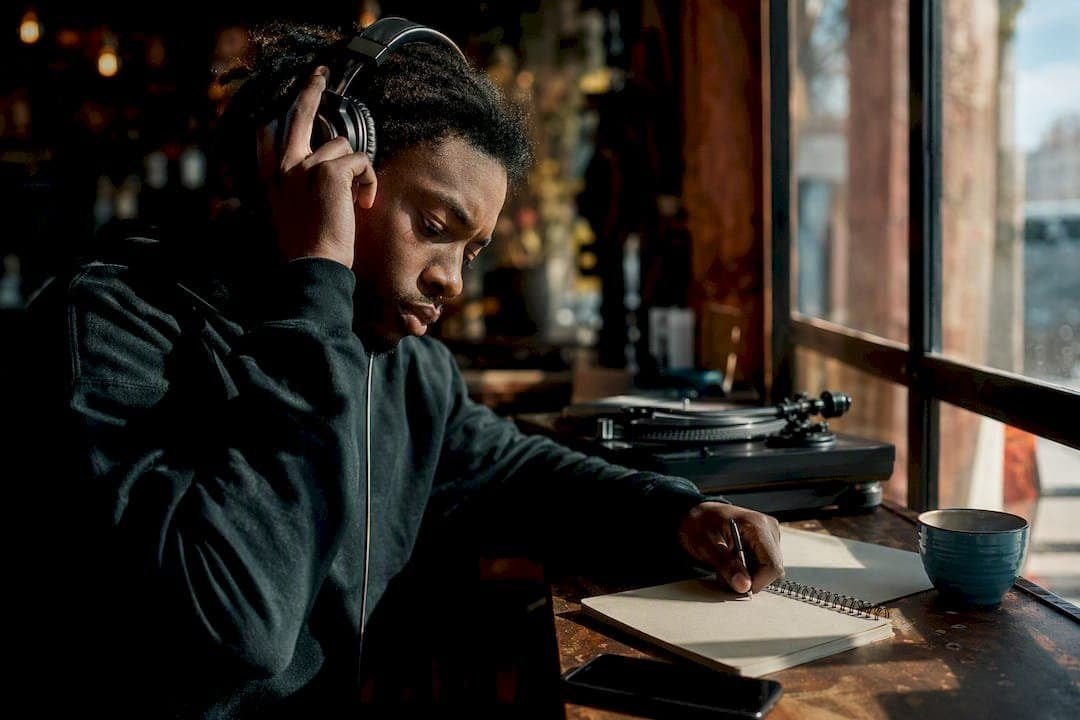 Urban artist listening to mixtapes on headphones