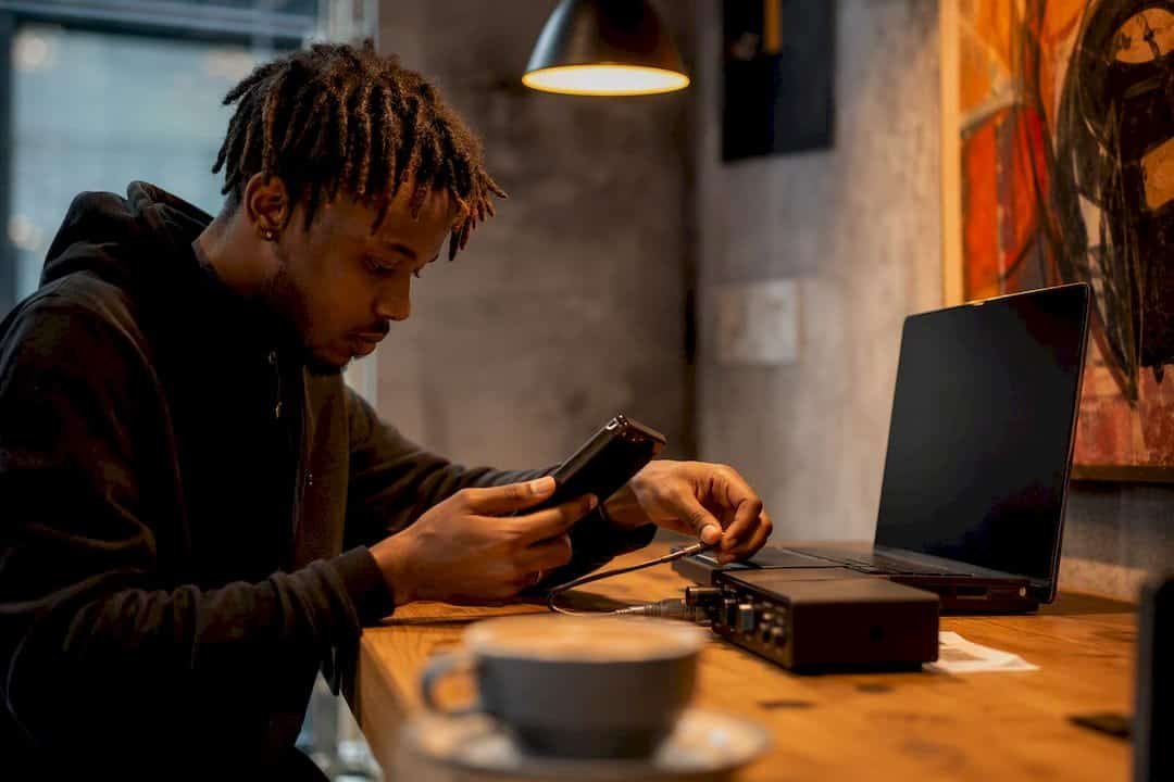 Artist uploading mixtape in urban studio