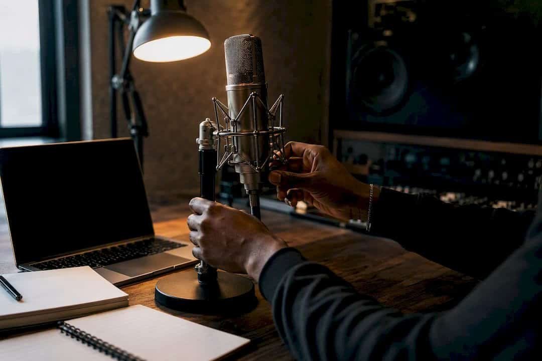 Hands adjusting headphones in studio space