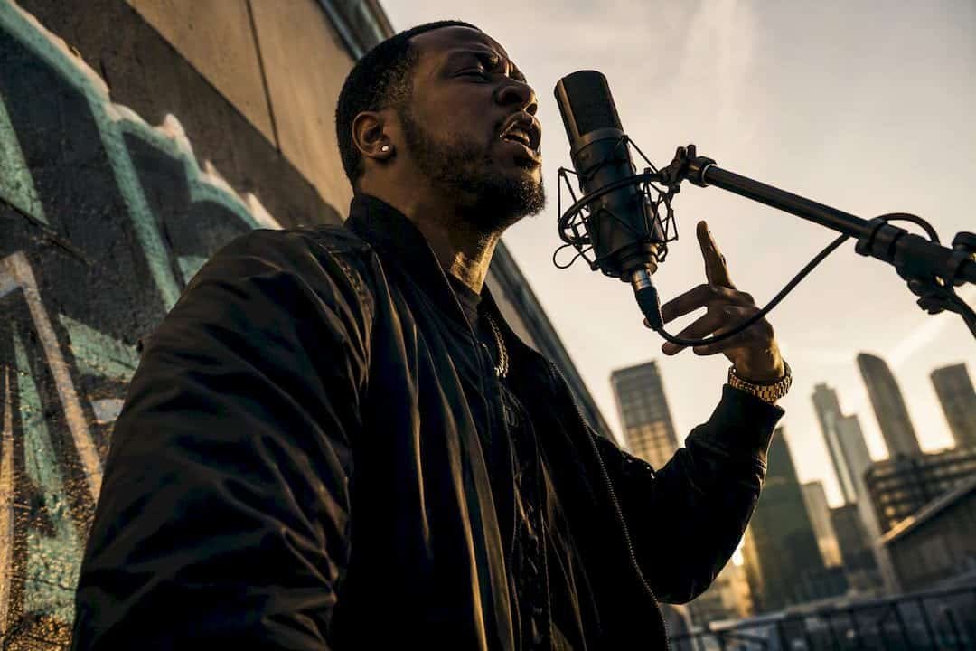 Rapper performing and writing lyrics in studio