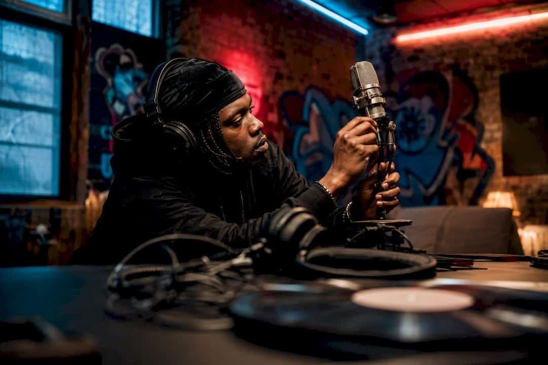 Artist tuning microphone in recording studio