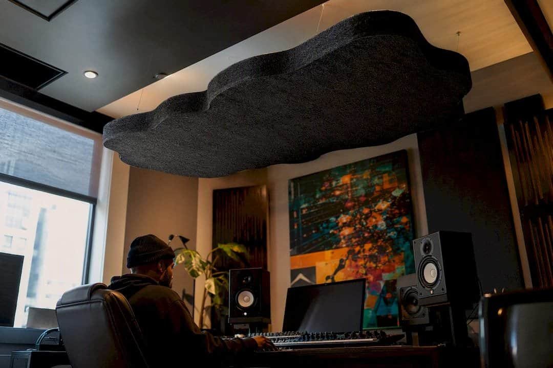 Ceiling cloud acoustic panel above desk
