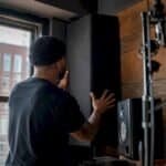Hands installing corner bass trap panel
