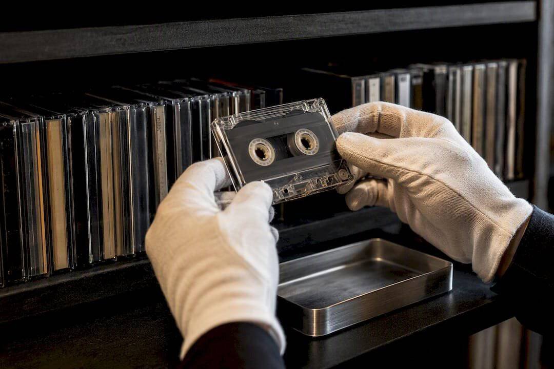 Archivist handling an anonymous cassette tape